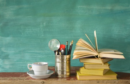 books with a cup of coffee and pens, free copy spaceの写真素材