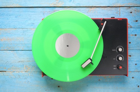 Retro turntable with green vinyl record, free copy spaceの写真素材