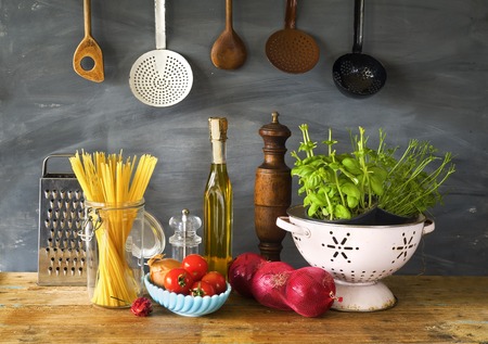 italian food ingedients, spaghetti, tomatoes, herbs, kitchen utensilsの写真素材