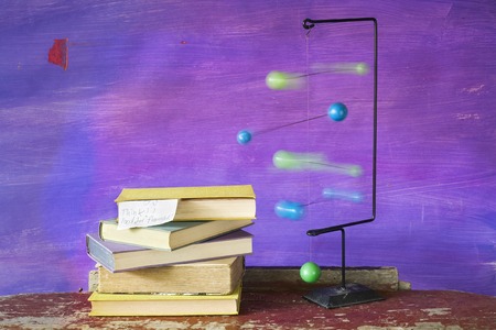 stack of book and a mobile, motion blur, thinking concept