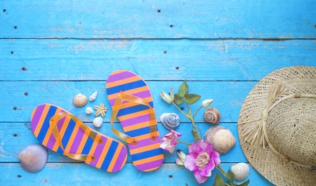 Summer sunbathing beach vacation concept, flip flops, seashells, good copy spaceの写真素材