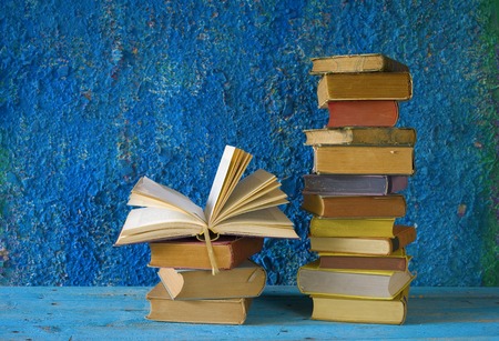 stack of books, one opened, grungy background,free copy spaceの写真素材