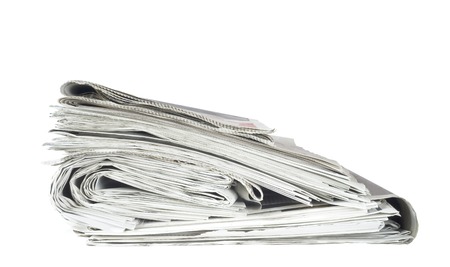 newspaper stack, isolated on white background, free copy spaceの写真素材