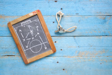 black board with tactical diagram,whistle of soccer trainer or referee, flat layの写真素材