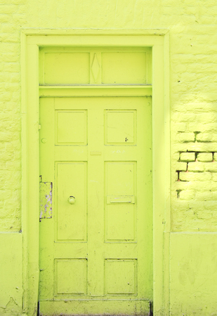 green painted door and wall of an abandoned house,grungy,free copy spaceの写真素材