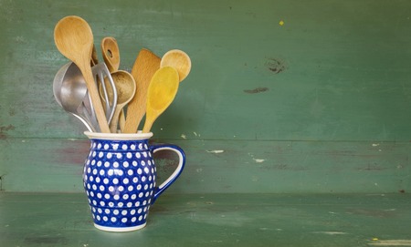 vintage kitchen utensils in an old jug
