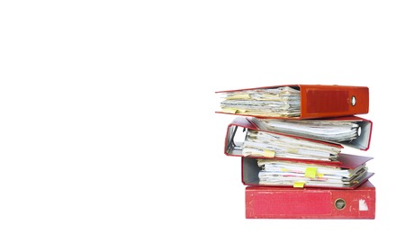 messy file folders and documents,isolated on white backgroundの写真素材