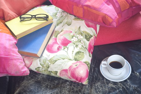 books on a sofa with cup of coffee and specs, reading, relaxing, literature concept