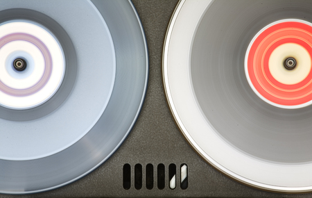 Vintage open reel, reel to reel audio tape recorder, close up of two tape spools in motion. Vintage audio technologyの写真素材