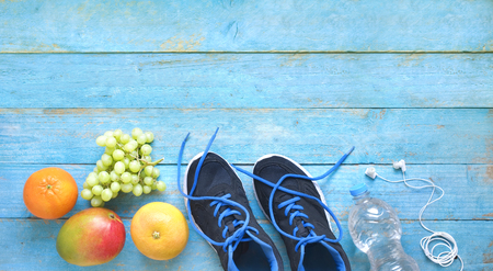 fitness, sport and reducing weight for the springtime, pair of runners and fruit,free copy space, flat layの写真素材