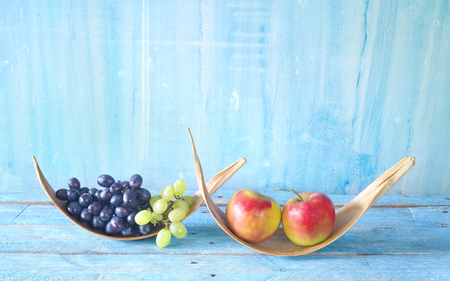 Grapes and apples on rustic table, dieting, healthy nutrition, fitness concept, good copy spaceの写真素材