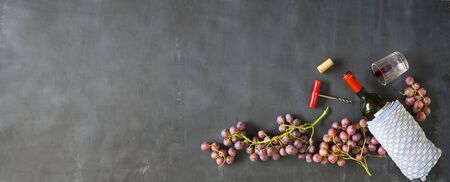 wine bottle,grapes,corkscrew and wine cork,flat lay, panoramic, free copy spaceの写真素材