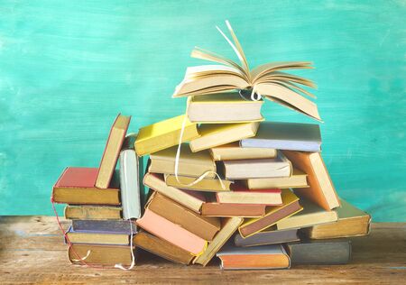 Open book on a pile of old books. Reading, learning, education, literature, good copy spaceの写真素材