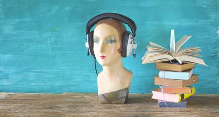 audio book concept with open book headphones and display dummy, mannequin, panoramic, good copy...