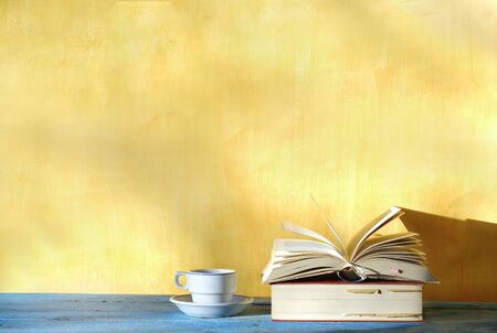 Open book, cup of coffee, free copy space. Reading, education, literature, learning, book fair concept の写真素材