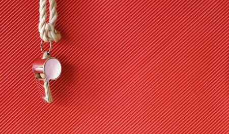 whistle of a soccer or football referee or trainer,on red background, mockup with free copy space, panoramic の写真素材