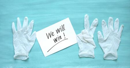 Fight the coronavirus, medical gloves with message - we will win - health care system improvement...