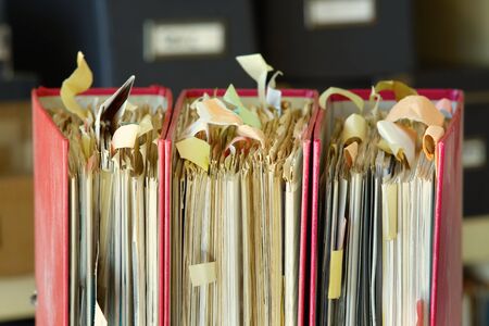 messy old file folders and documents,government, business and administration shutdown in times of coronavirus,conceptual picture, narrow focus,close-upの写真素材