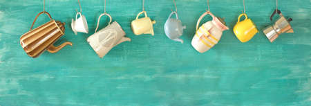 Vintage coffee pots, filters and mug hanging on green wall, panoramic format, large copy spaceの写真素材