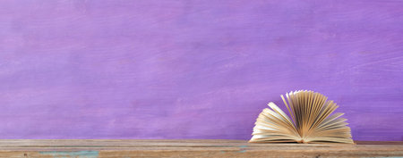 An opened book, reading, literature, education, library, home office, panoramic with free copy spaceの写真素材