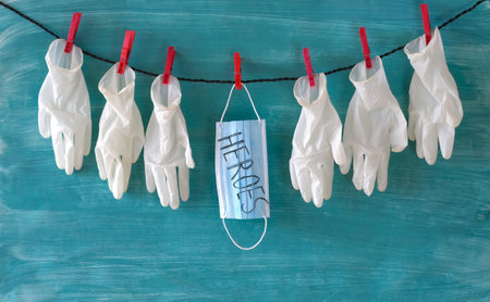 respect for the staff of the health care system symbol picture, medical gloves corona mask displaying the message "Heroes", covid-19, corona virusの写真素材