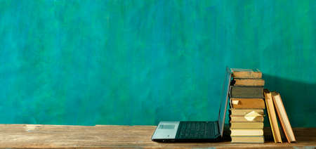 Stack of books and laptop computer,home office, homeschooling,reading,education, business concept. Free copy spaceの写真素材