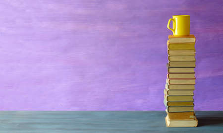 Stacks of books and a cup of coffee, reading, learning,home office and education concept, free copy...