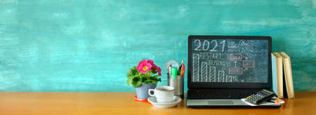 Global recovery and restarting business in 2021 after virus. Workspace,home office with laptop...