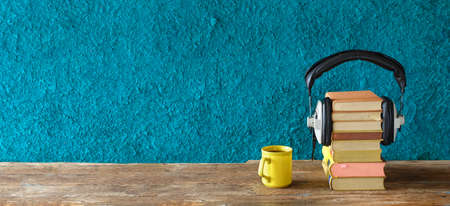 audio book concept books and vintage headphones, orange and teal look, literature, entertainment, education, good copy spaceの写真素材