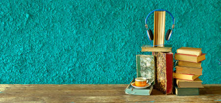 audio book concept, vintage books and headphones,orange and teal look, literature,entertainment,education, good copy spaceの写真素材