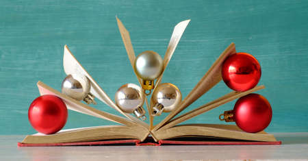Giving books for christmas with open book, christmas balls and decoration.Reading, literature,...
