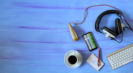 Music or podcast background with stylish headphones,vintage microphone,coffee and computer keyboard...
