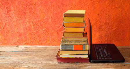 home office,education,business,concept with laptop computer and heap of books,free copy spaceの写真素材