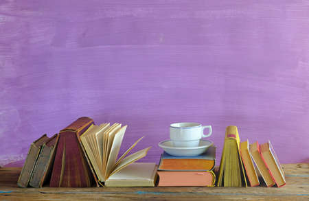 home office,education,business,concept with  row of books and cup of coffee, purple background, free copy space, negative space techniqueの写真素材
