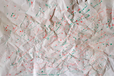 Crumpled paper bacckground with paint splashes