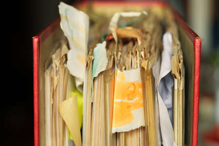 Messy, grungy file folder ,red tape,close up, selective focus.Bureaucracy,aministration,business...
