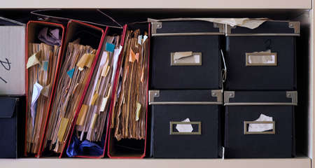 Row of messy file folders,red tape,close up, bureaucracy,aministration,business concept.の写真素材