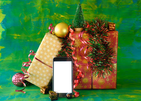 Christmas shopping online.Buying christmas  presents using smartphone.Gift boxes and phone.Free copy...