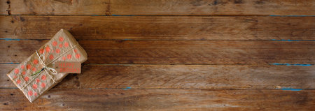Gift box with tag on wooden background, free copy space, panoramic