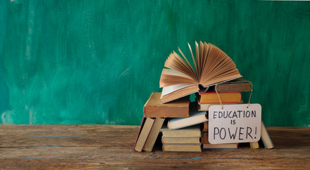 Open book, hardback books with education is power sign on teal background.,education,reading. Free  copy spaceの写真素材