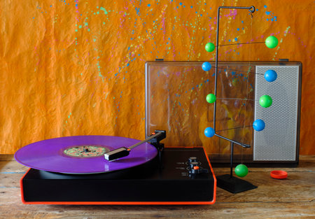 vintage turntable with purple vinyl record, speaker and pop art objectの写真素材