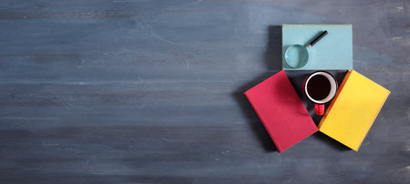 books and a cup of coffee,education,reading,knowledge, home office concept, modern art inspired flat lay.Panoramic, large copy space.の写真素材