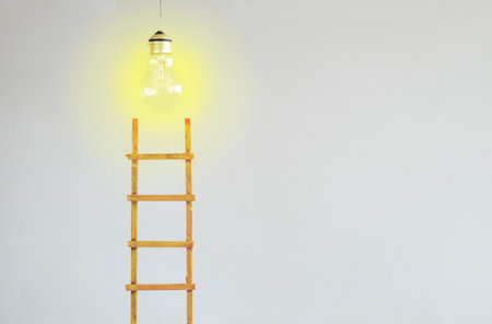 Business vision development and idea concept,Ladder of success  leading to a lght bulb. Business concept, idea,success,innovation,start up concept.Large copy spaceの写真素材