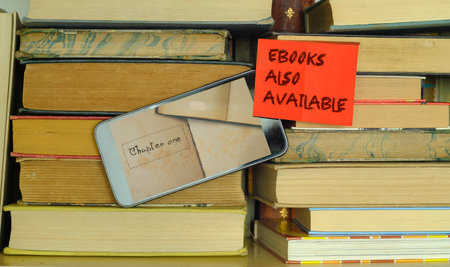 e book concept with stack of books,e book reader and sign with  message e books also availableの写真素材