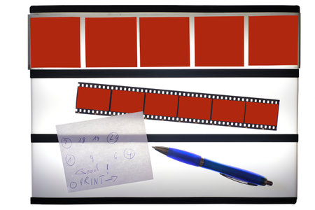 Analog film photography concept, light table with film stripes and empty picture frames, pen and note. Free space for pics,の写真素材