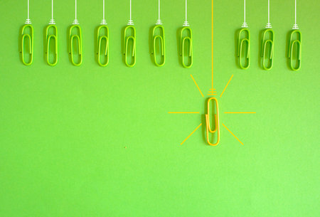 concept,metaphor,idea,solution,innovation,idea,unique selling point,start up and human resources concept with paper clips as lightbulbs, flat lay, copy spaceの写真素材