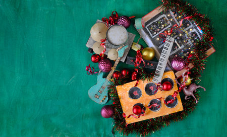 Musical instruments for Christmas with grungy cardboard models of musical instruments, synthesizer, drum kit, guitar, amplifier, Christmas decoration, free copy space, flat layの写真素材