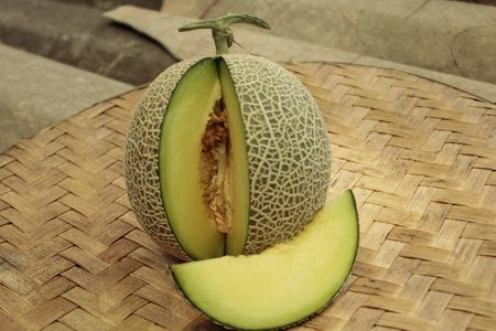 Melon on a bamboo cutting board, closeup of photo.