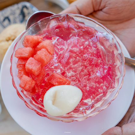 Watermelon smoothie with ice in glass on wooden table, stock photoの写真素材