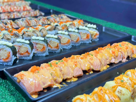 Sushi and rolls on display at a Japanese food market in Thailandの写真素材
